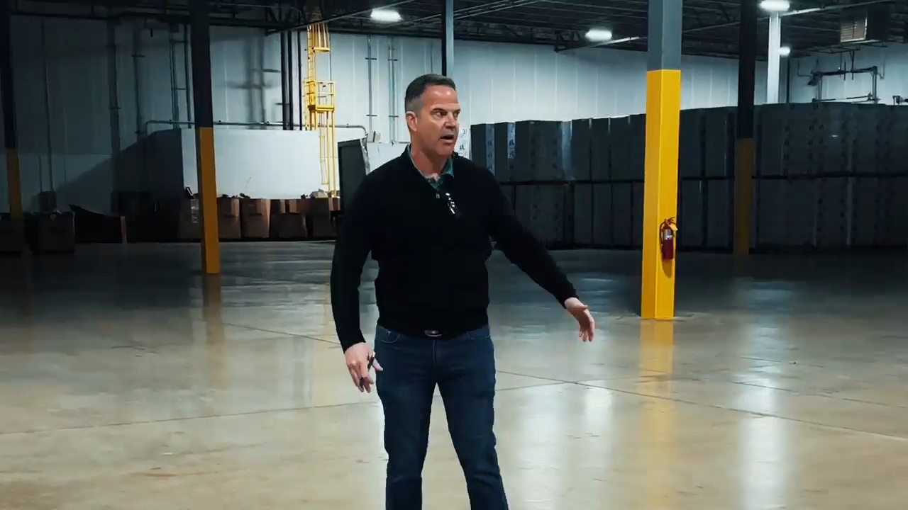Eric Williams walking through a warehouse in eJOOV's video about its Virginia operations