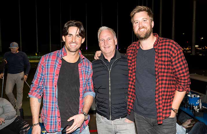 Erik Anderson standing between musicians Jake Owen and Charles Kelley at a Topgolf Nashville charity event