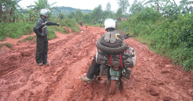 Motorcyclists negotiating a deeply muddy road during the journey across Africa