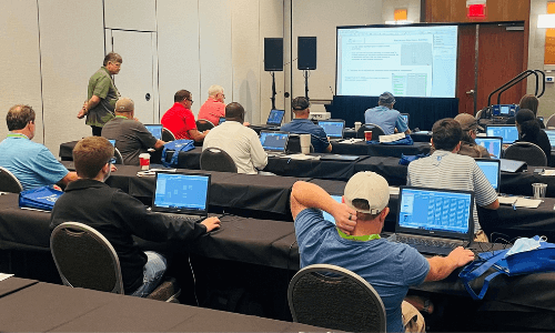 Participants using laptops during an ESC Spectrum software training session
