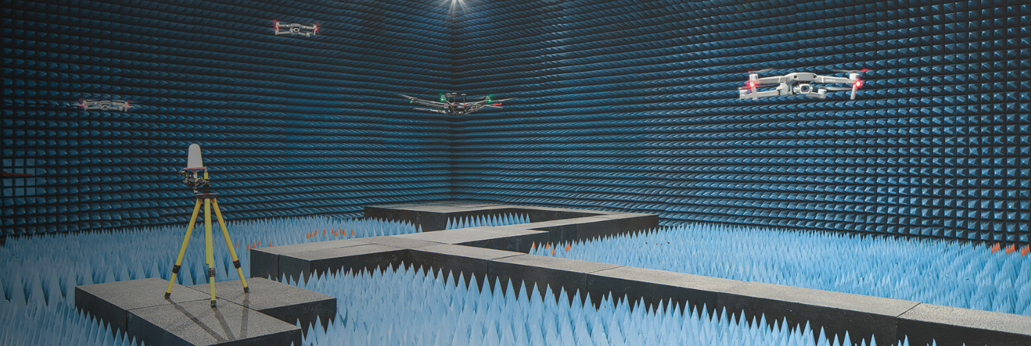 ESCO corporate illustration of drones inside a blue RF test chamber lined with pointed absorptive material