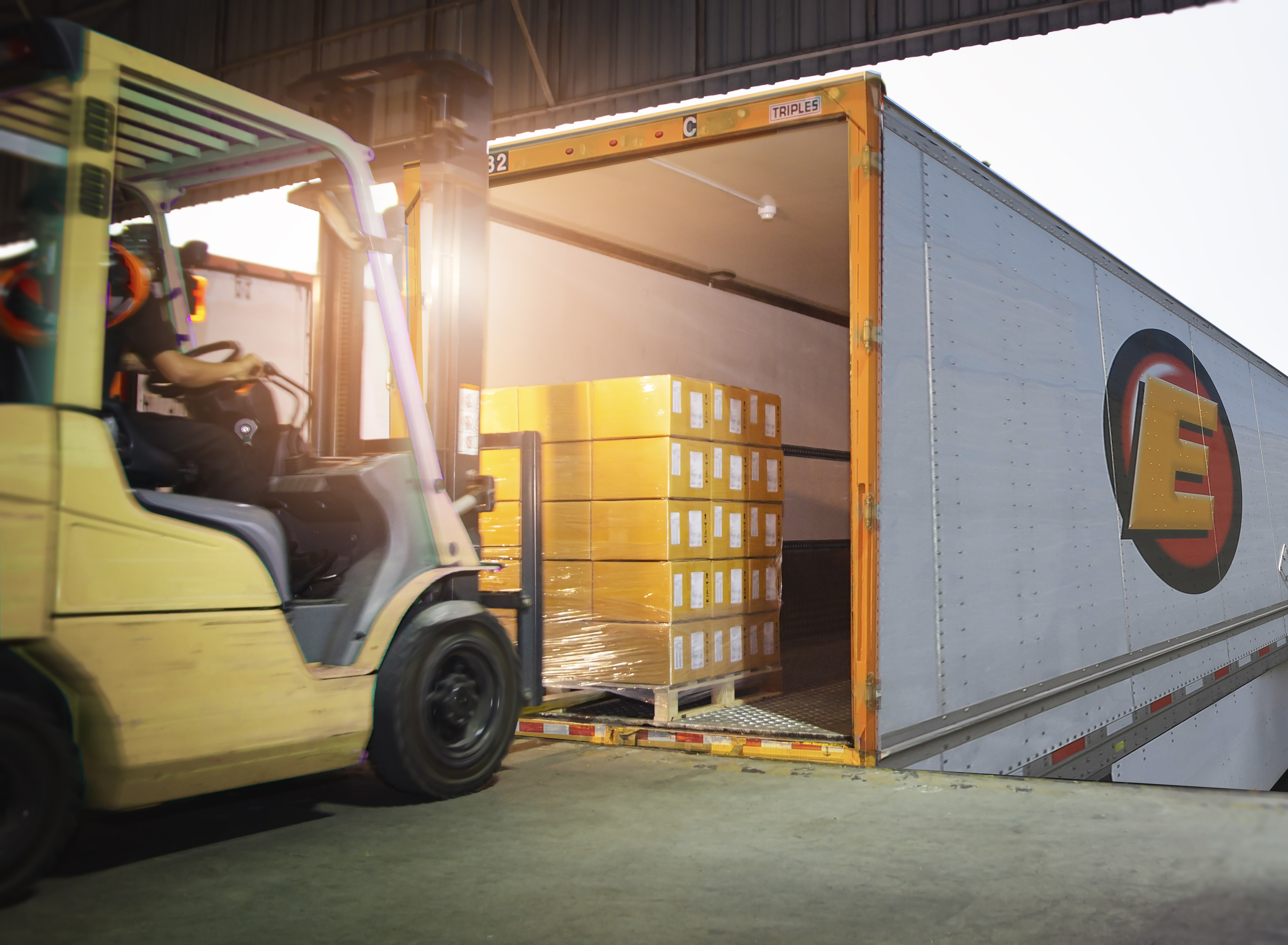 Estes forklift loading palletized freight into a trailer