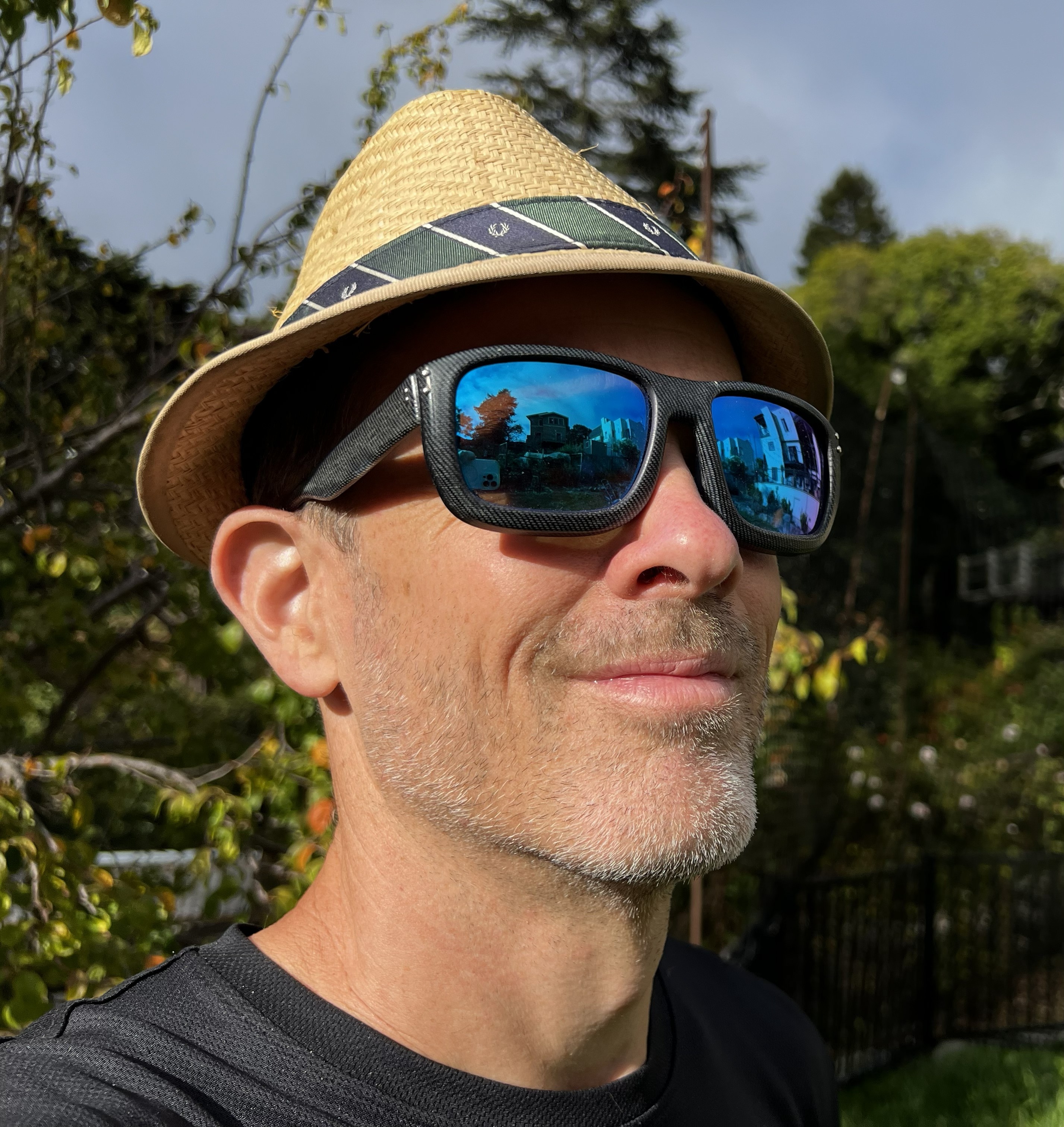 Ethan Escowitz in a straw hat wearing sunglasses made with almond-shell composite material