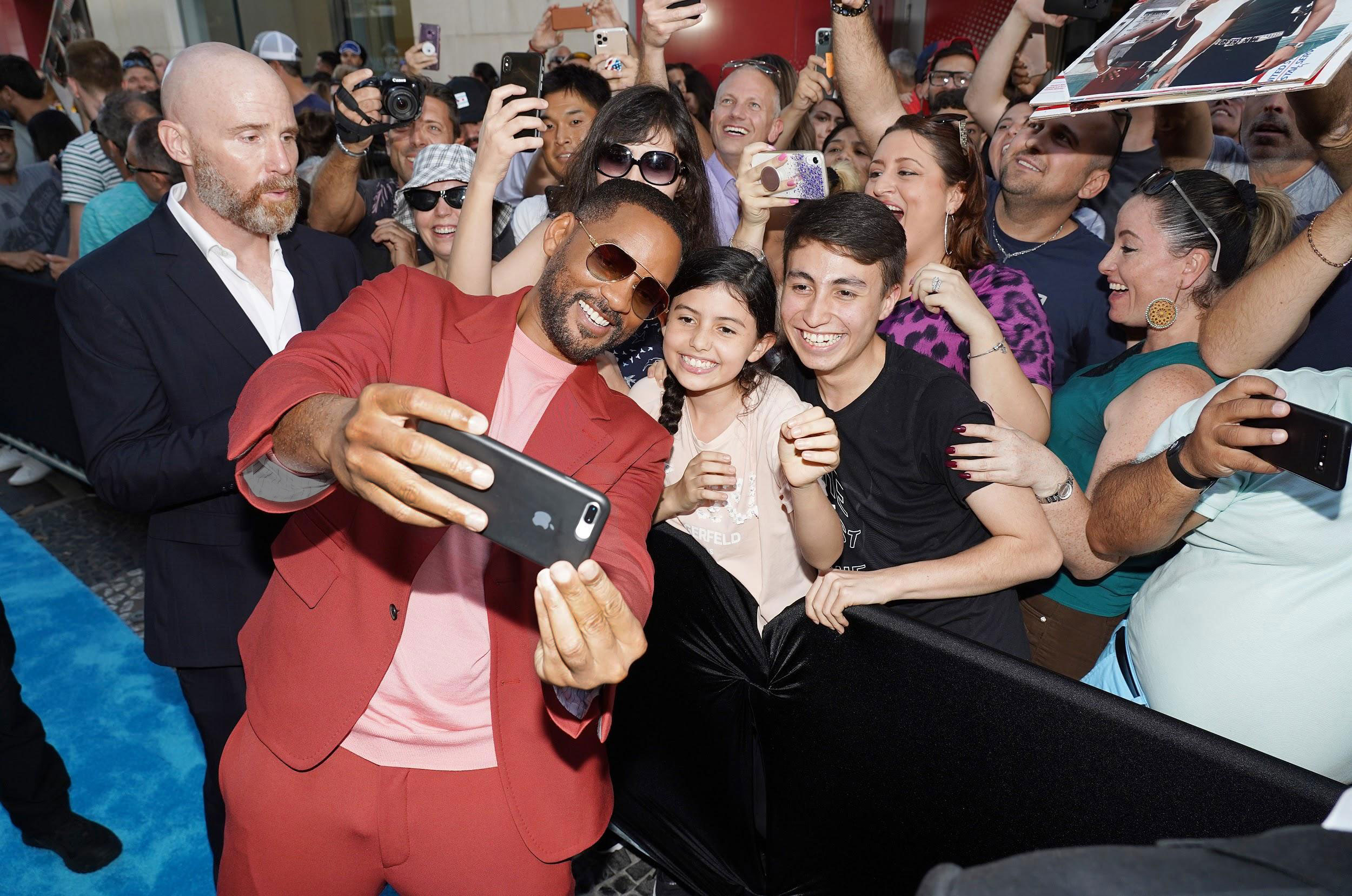 Will Smith takes a selfie amid a crowd at the Miami premiere of Bad Boys for Life