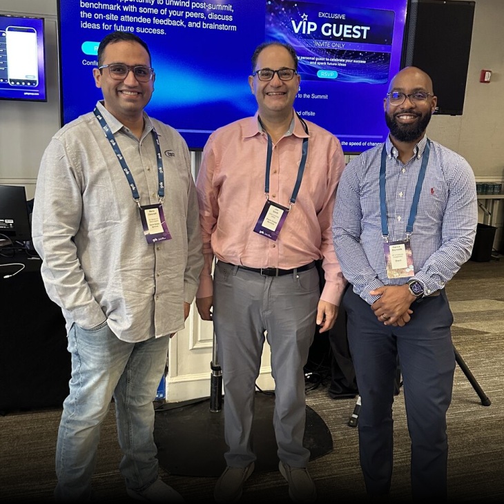 Three attendees in an event photograph published by ETS Labs
