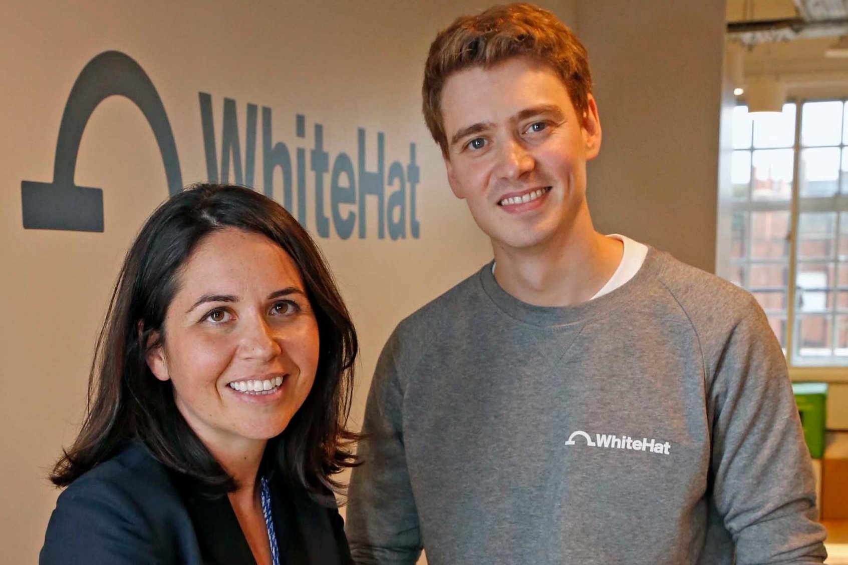 Sophie Adelman and Euan Blair standing together in the WhiteHat office