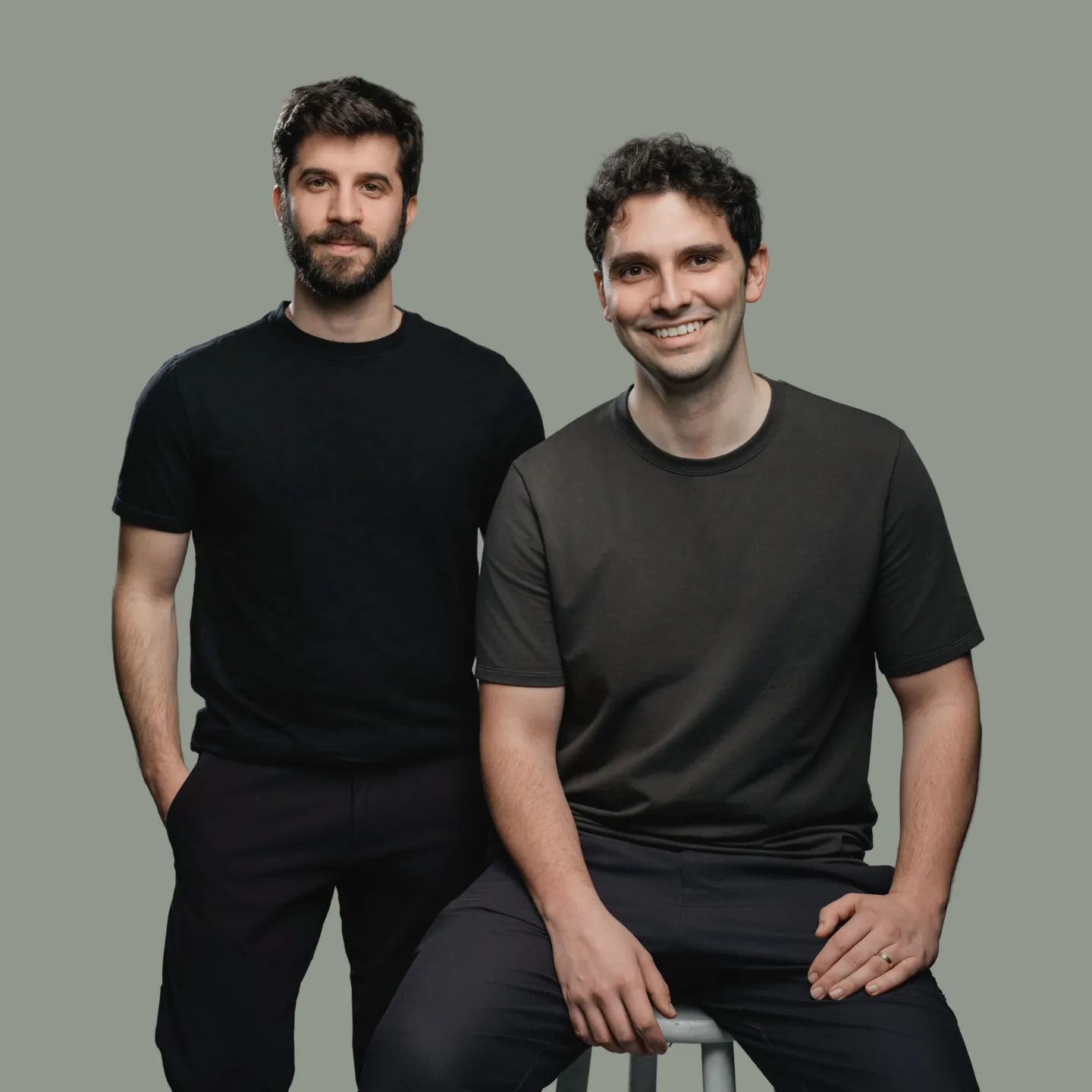 Edra co-founders Yannis Karamanlakis and Eugen Alpeza together against a gray-green background