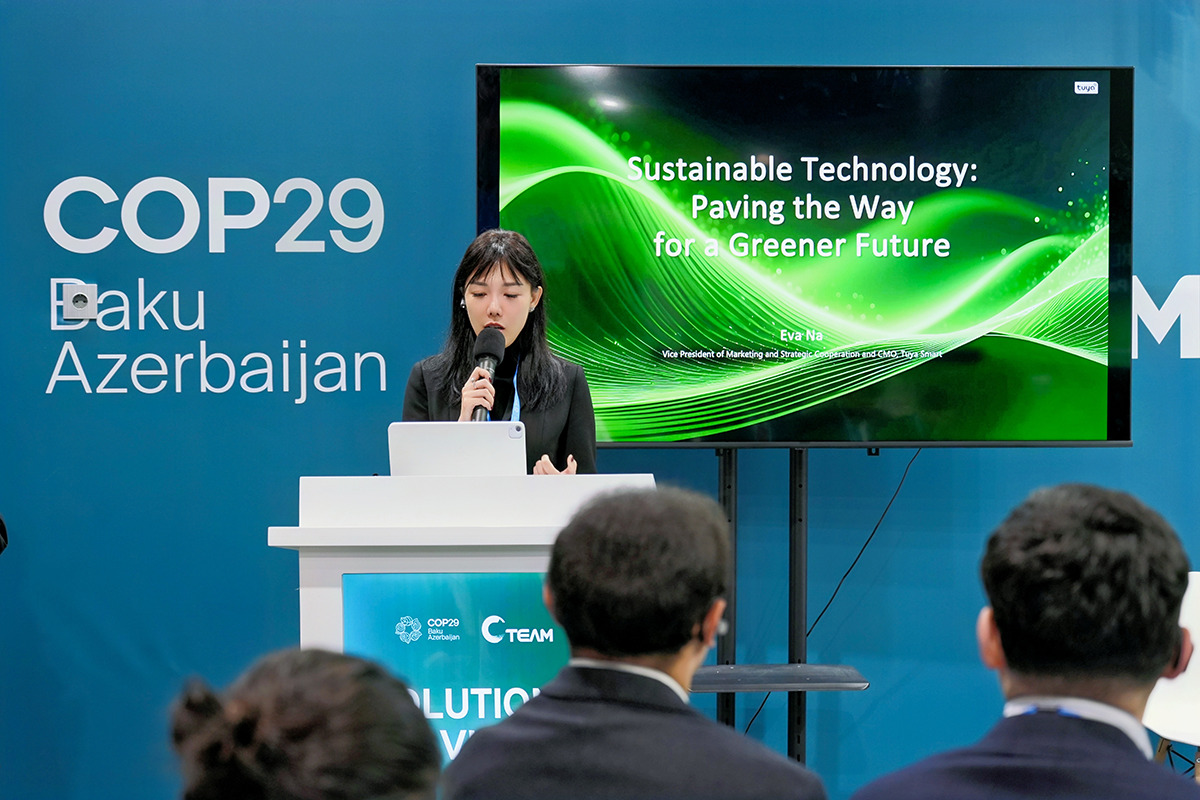 Eva Na speaking at a COP29 side event in Baku beside a presentation on sustainable technology