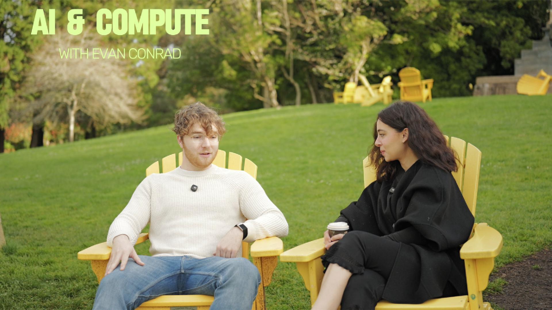 Evan Conrad speaking with an interviewer outdoors in yellow chairs