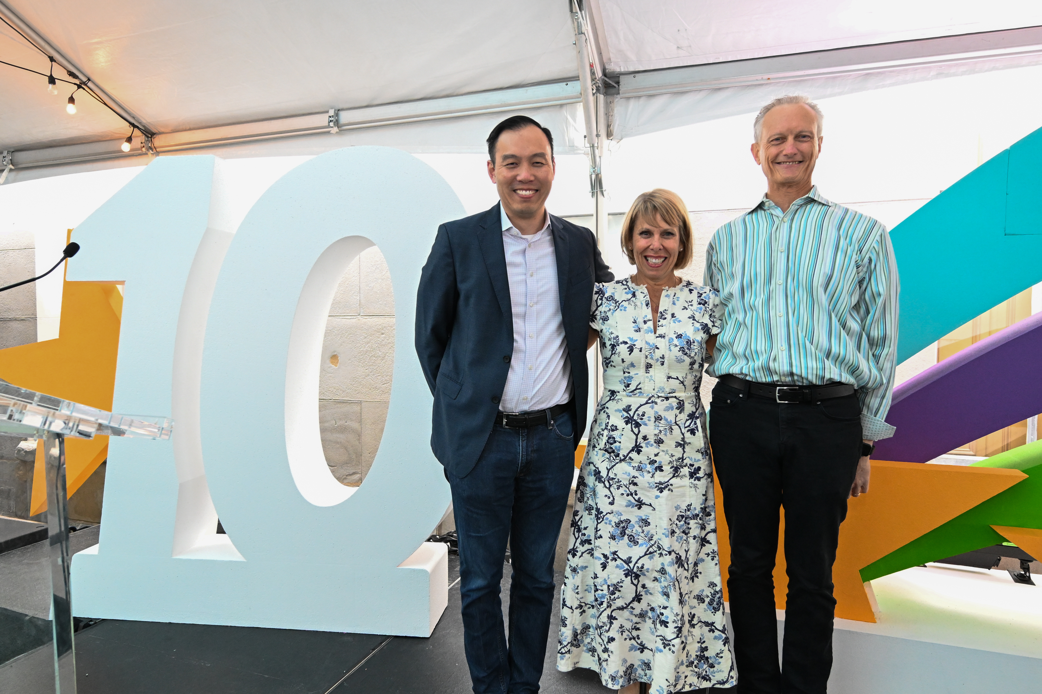 Evan Liang, Katy Keim and Jim Bell standing together at OpsStars 2025