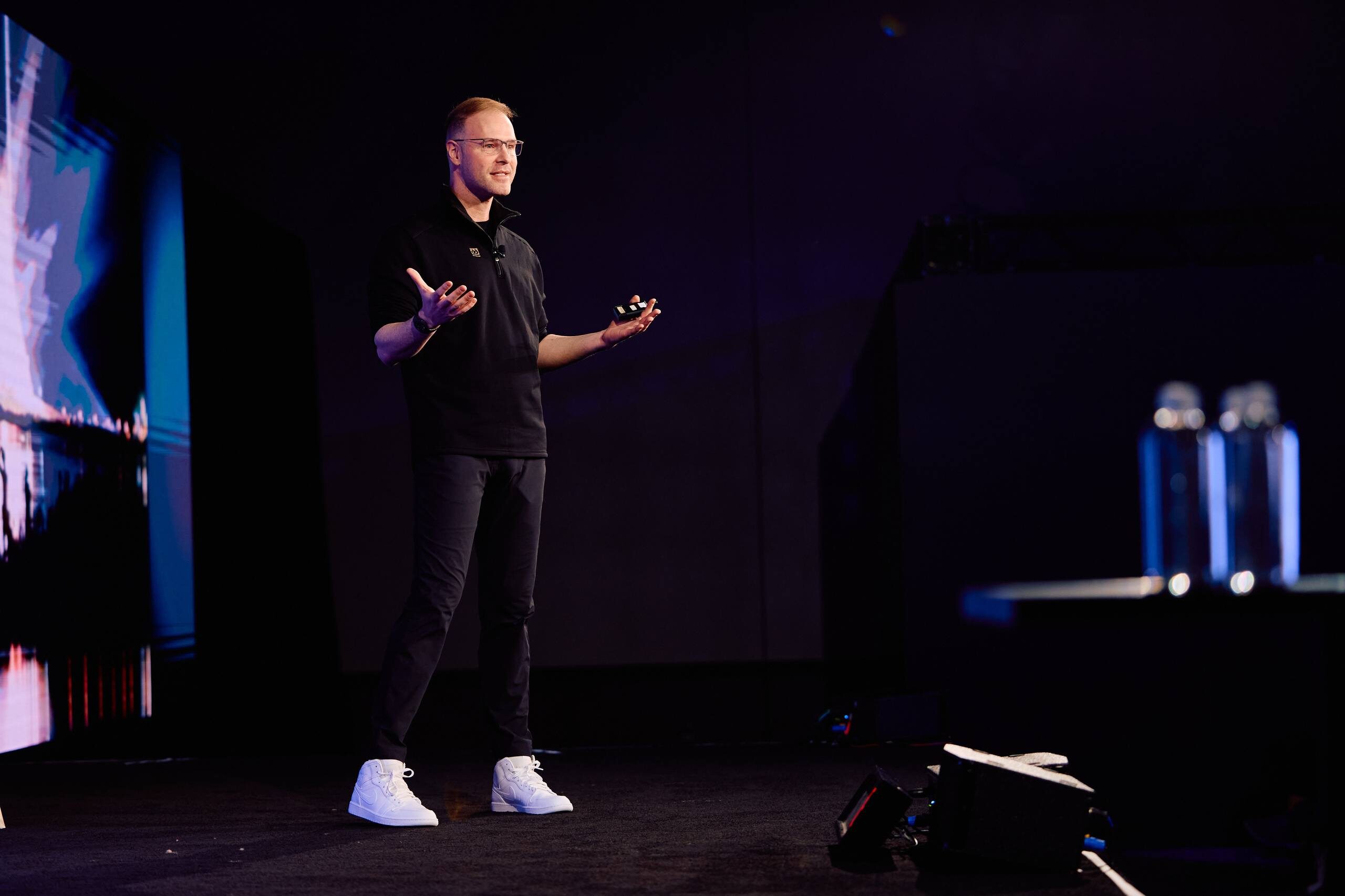 Evan Reiser speaking on a dark conference stage