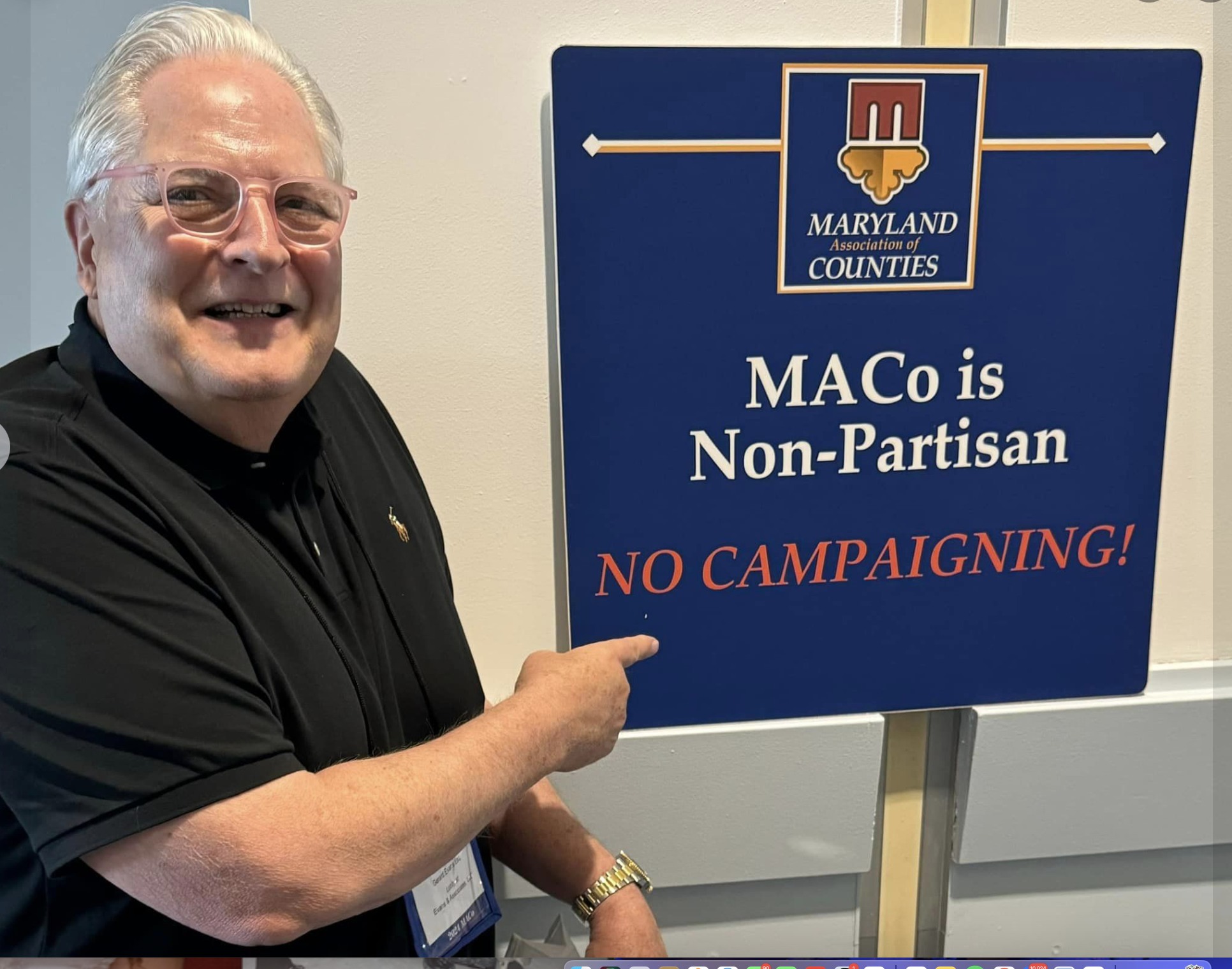 Gerard Evans points to a sign at the Maryland Association of Counties conference