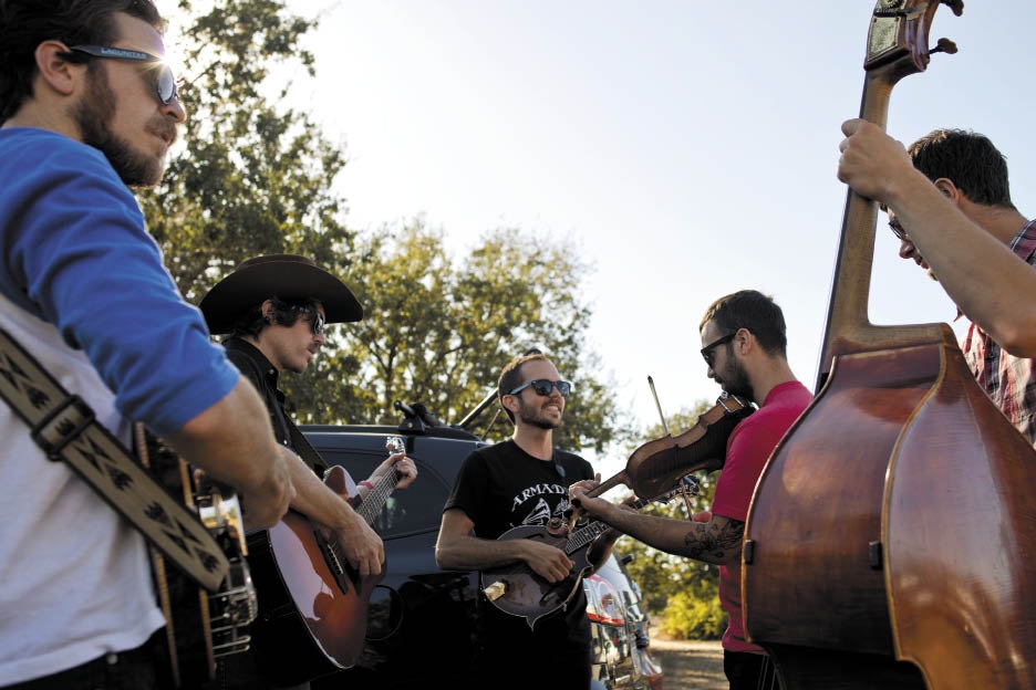 The Brothers Comatose gather with acoustic instruments backstage at EarleFest in 2014