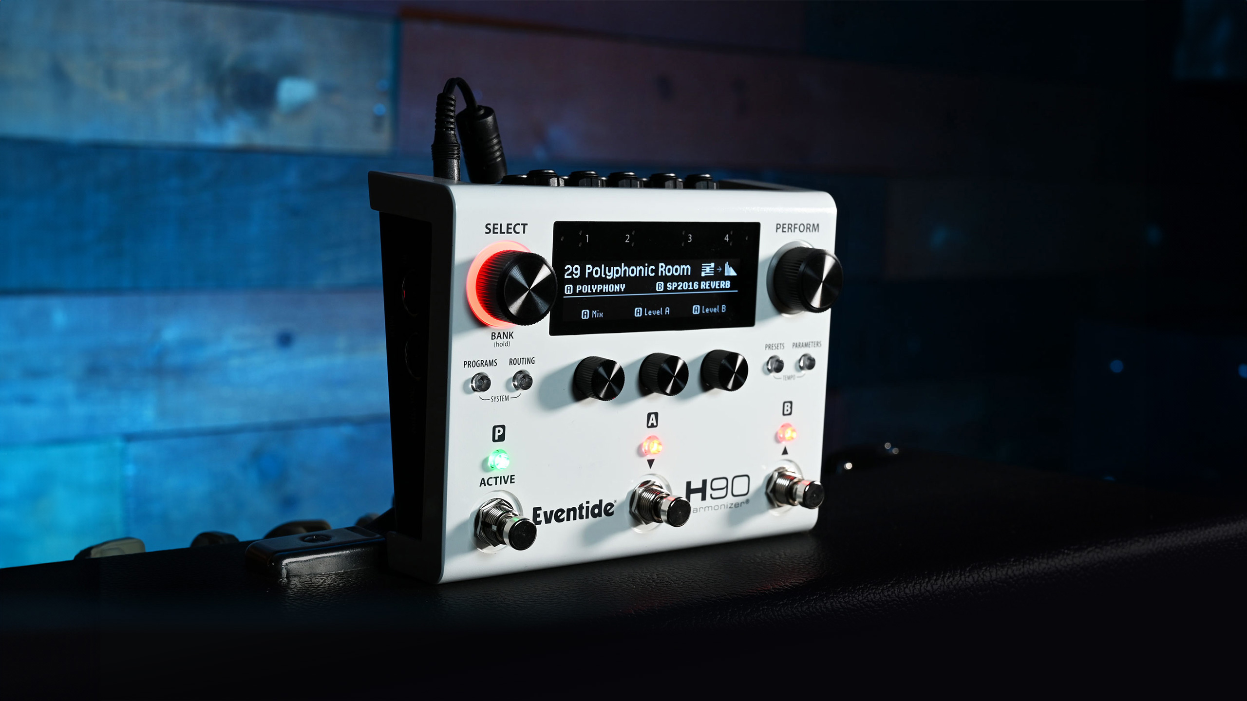 Eventide H90 Harmonizer pedal lit on a dark studio surface