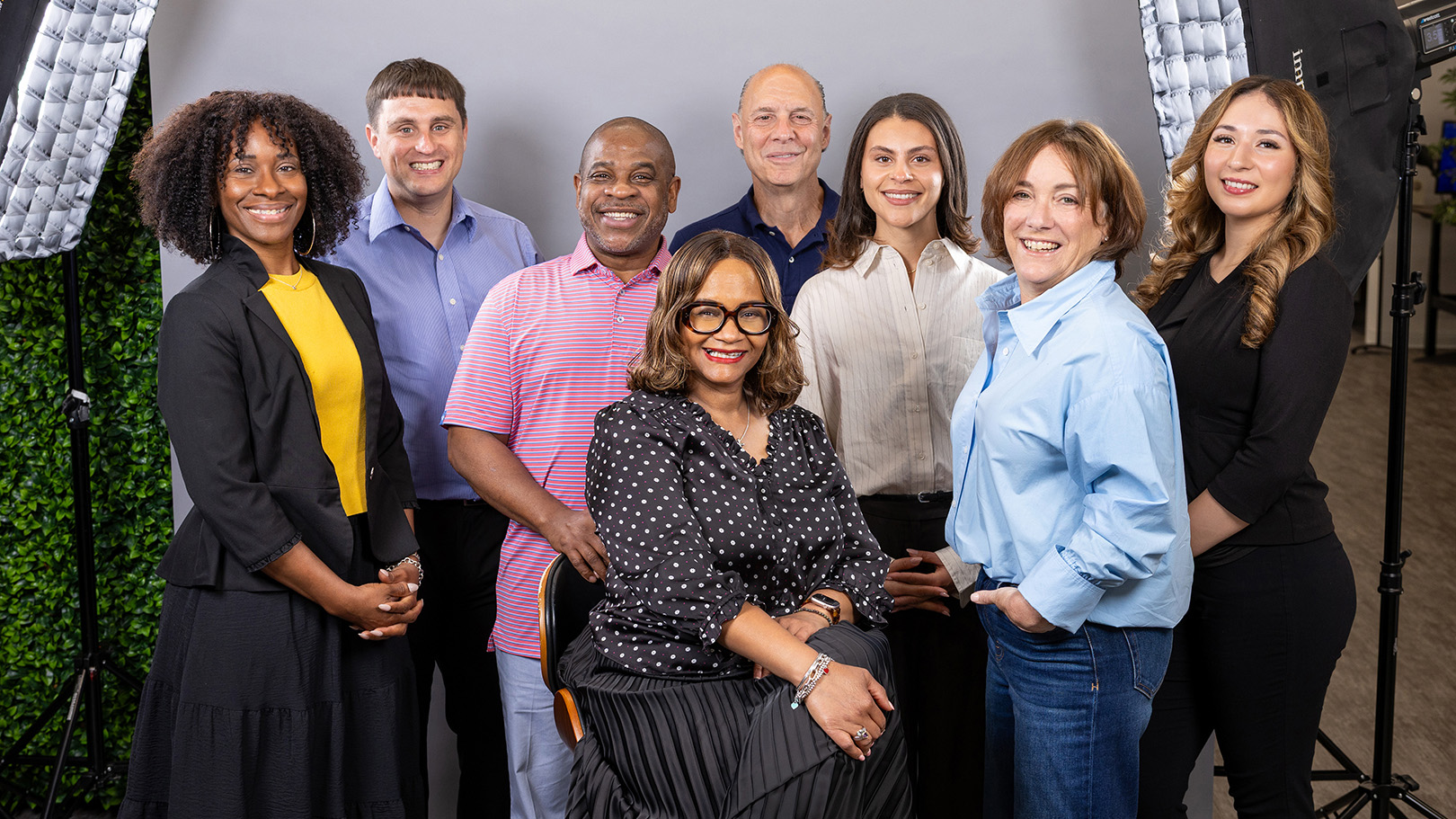 Chereese Jervis-Hill seated with seven members of the Events to Remember 360 Marketing team