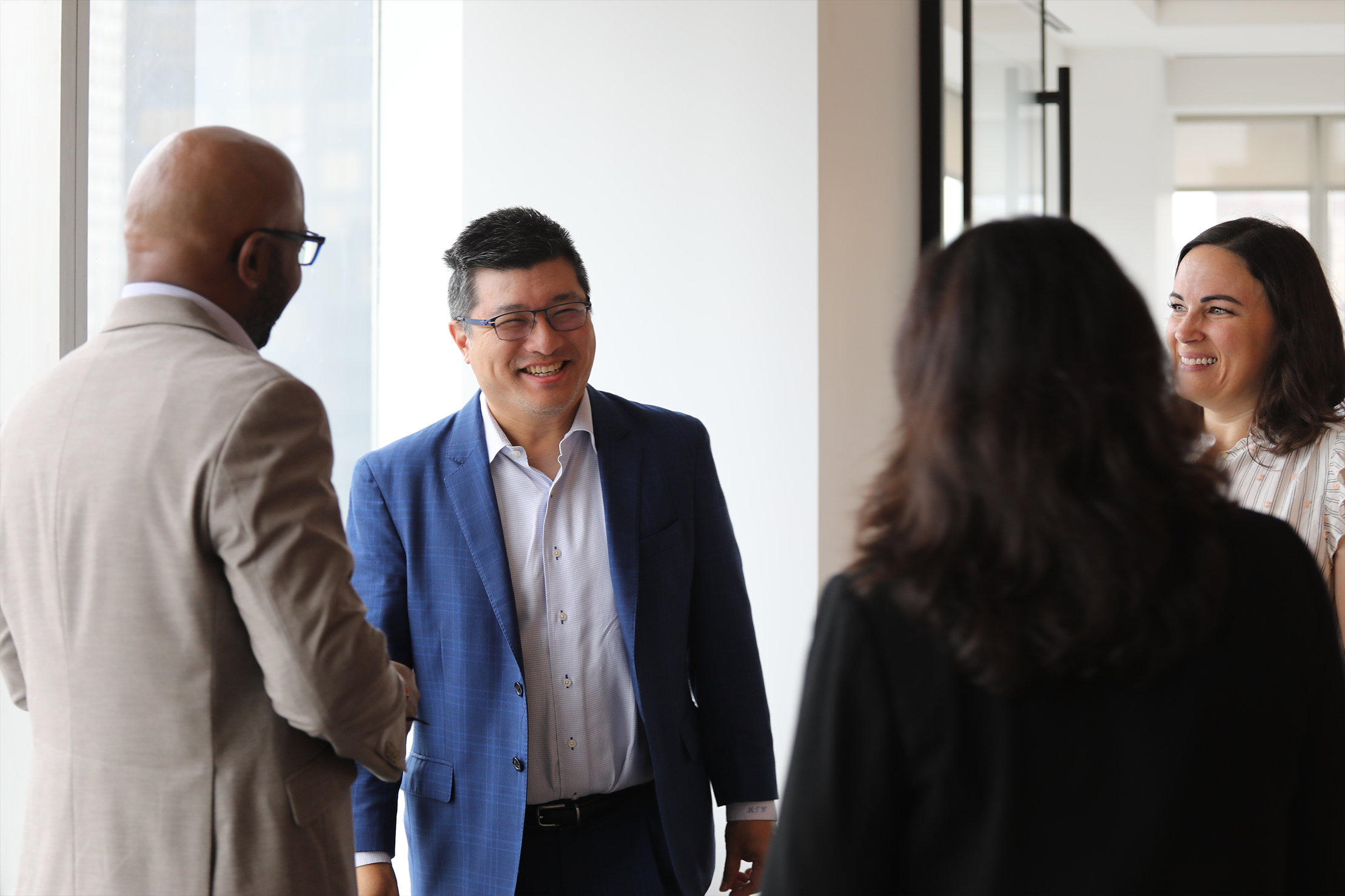 Evercore colleagues talking together in a bright office