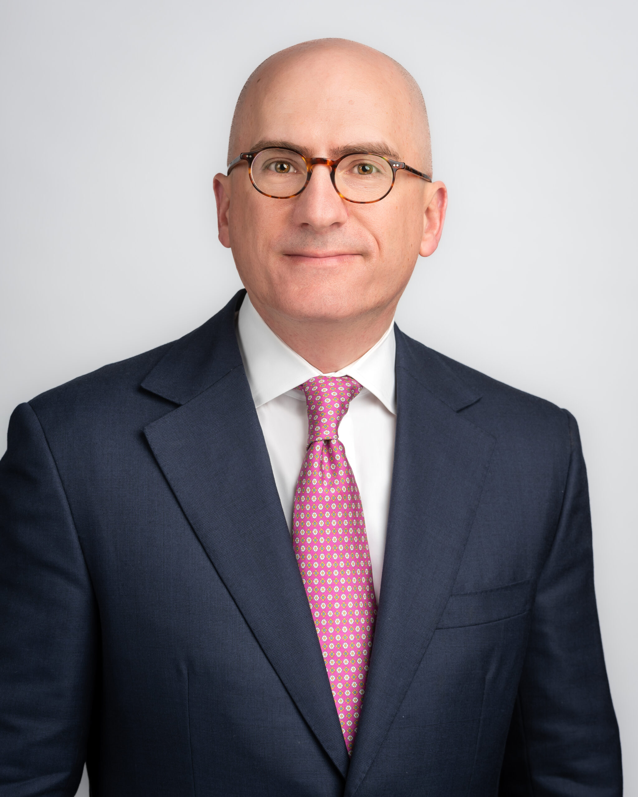 Everest President and Chief Executive Officer Jim Williamson, wearing glasses and a dark suit