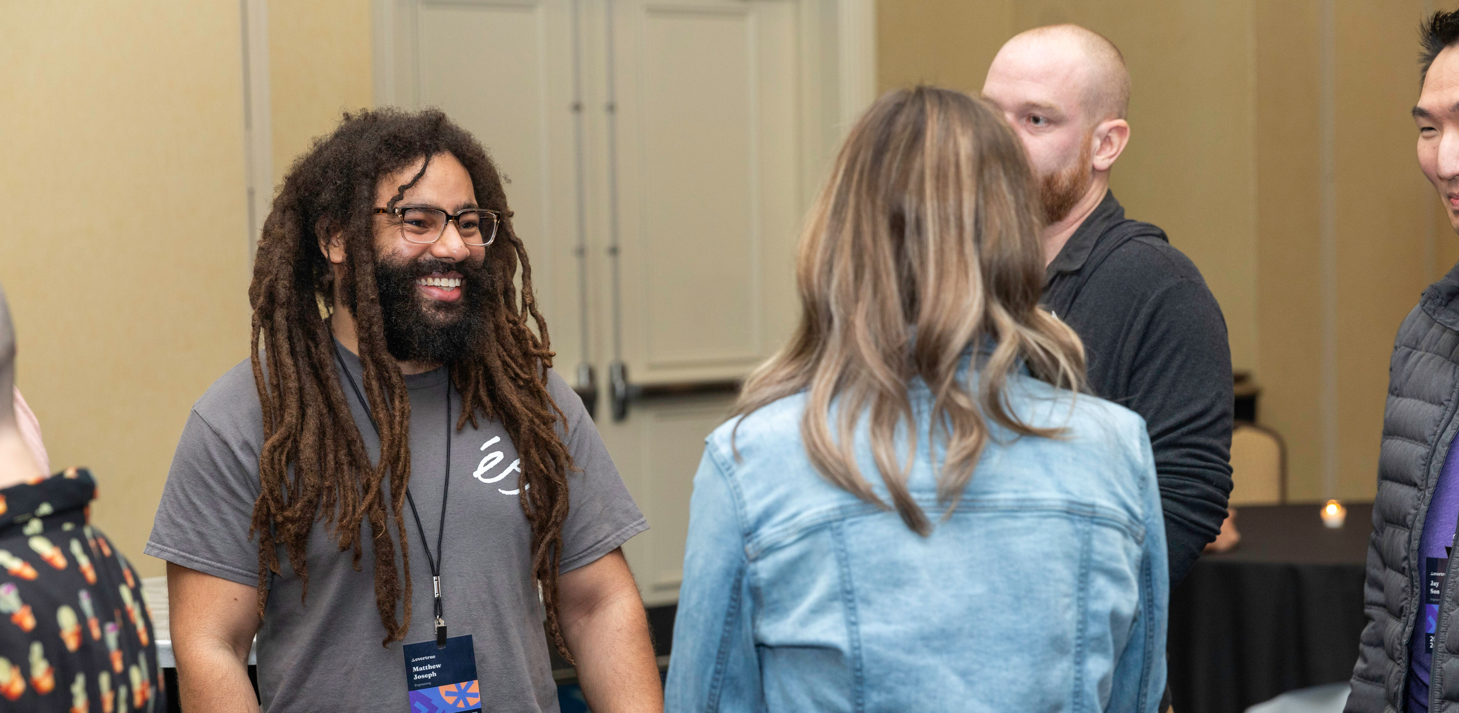 Members of the EverTrue community talking at a company event