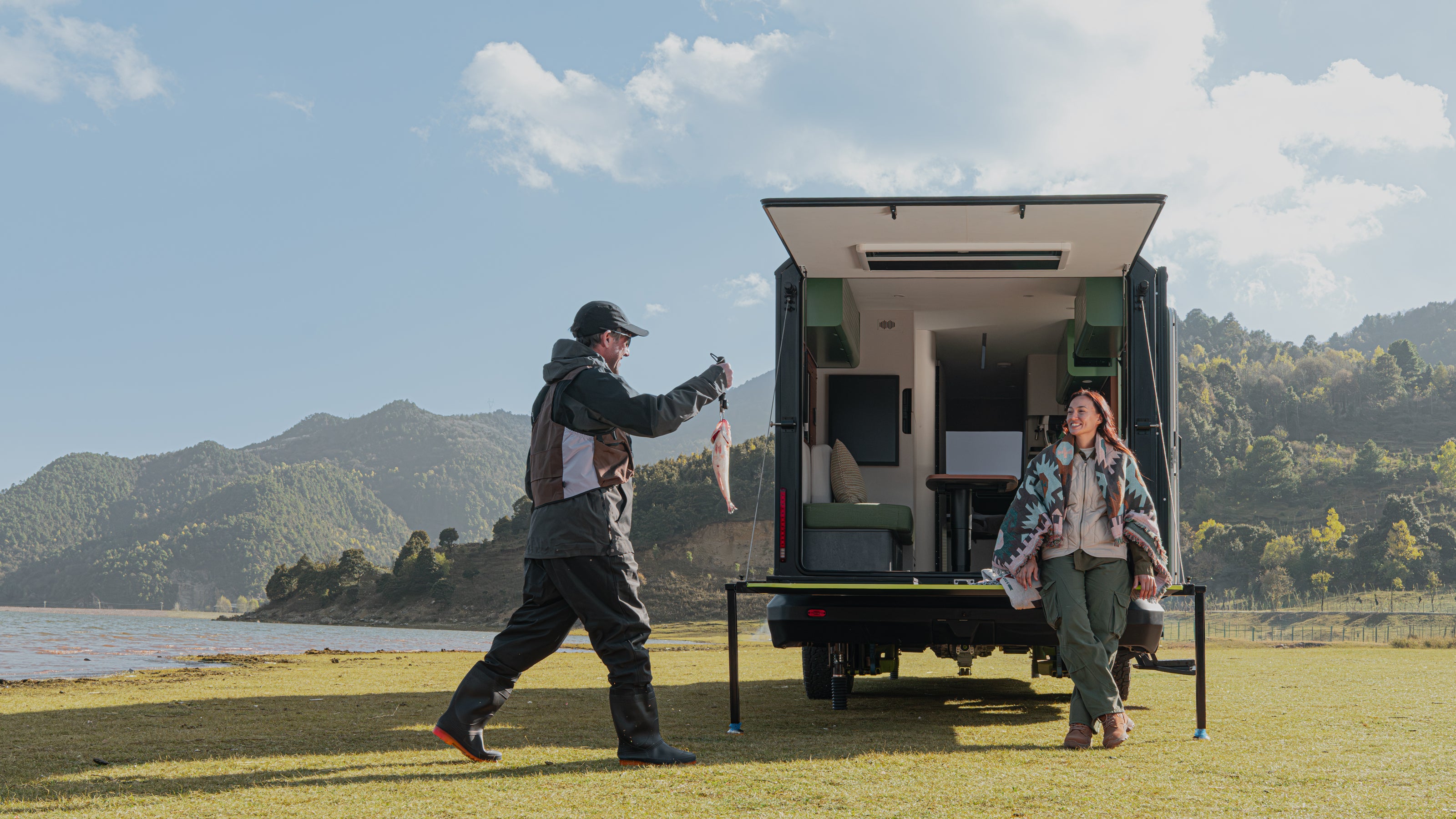 Evotrex PG5 pre-production trailer with rear patio open beside a lake