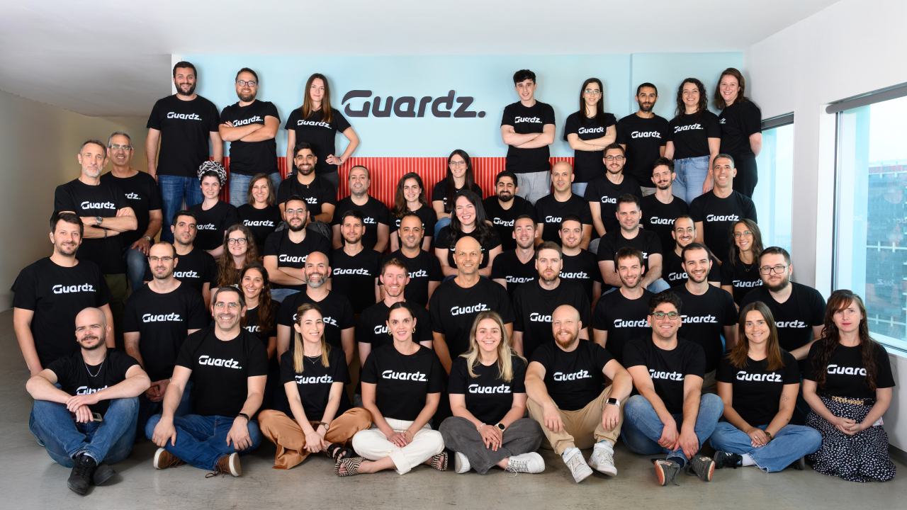 The Guardz team gathered in black company shirts at its office