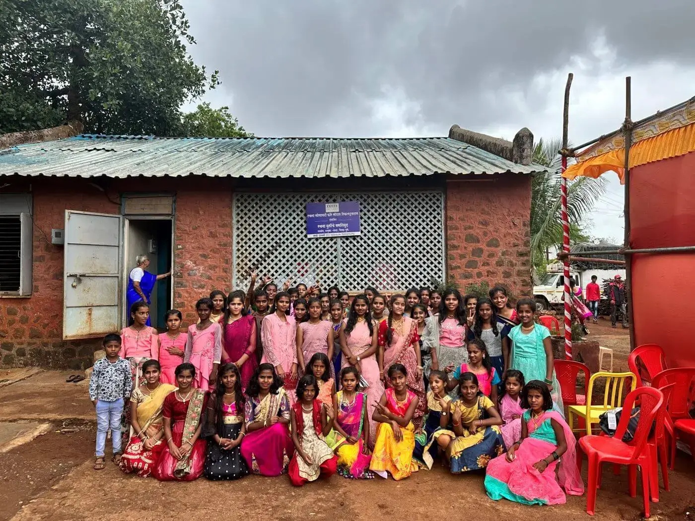 A group gathered outside Rachana Girls Hostel in a photograph published with Excelencia’s education initiative