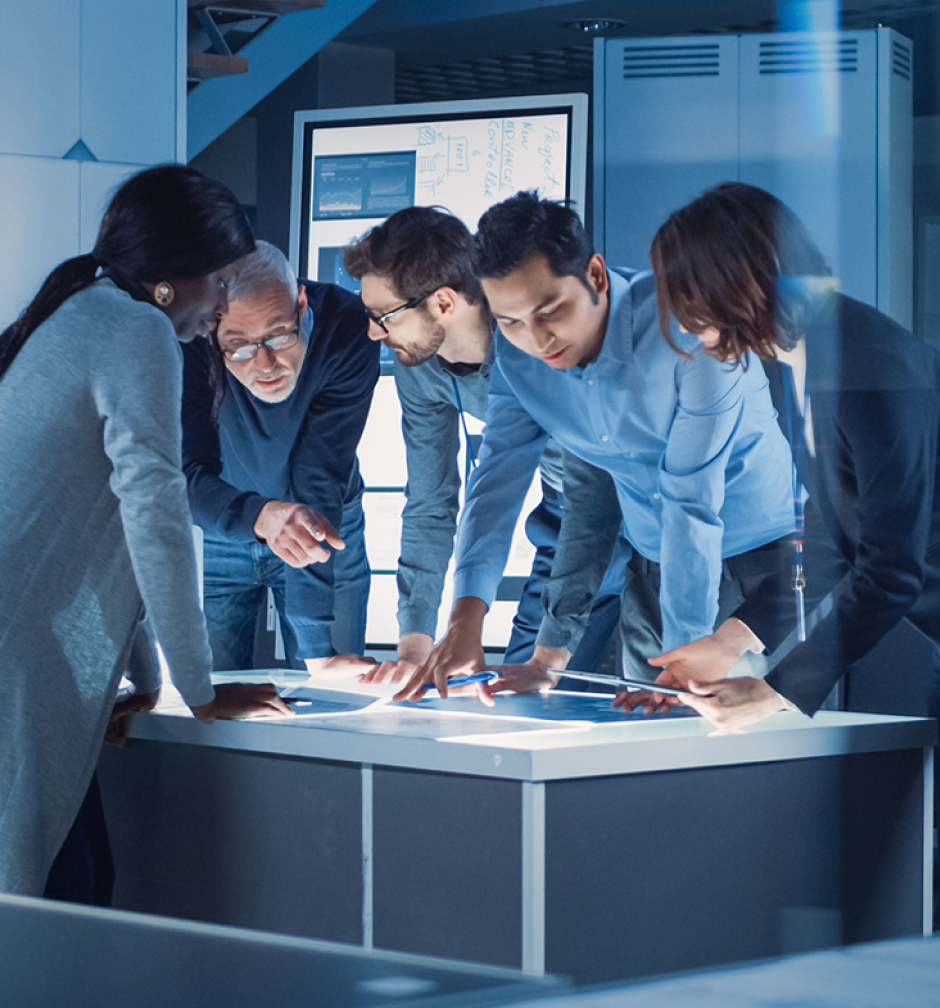 Engineers gathered around an illuminated work table in Expedera's company imagery