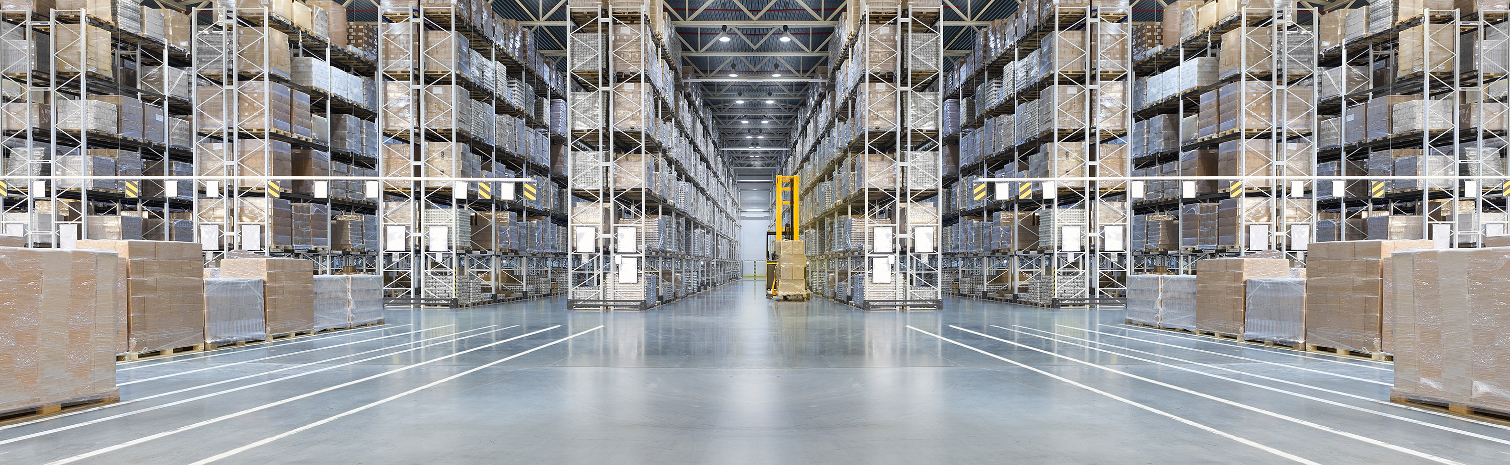 Long rows of pallet racks in a warehouse pictured by Expeditors