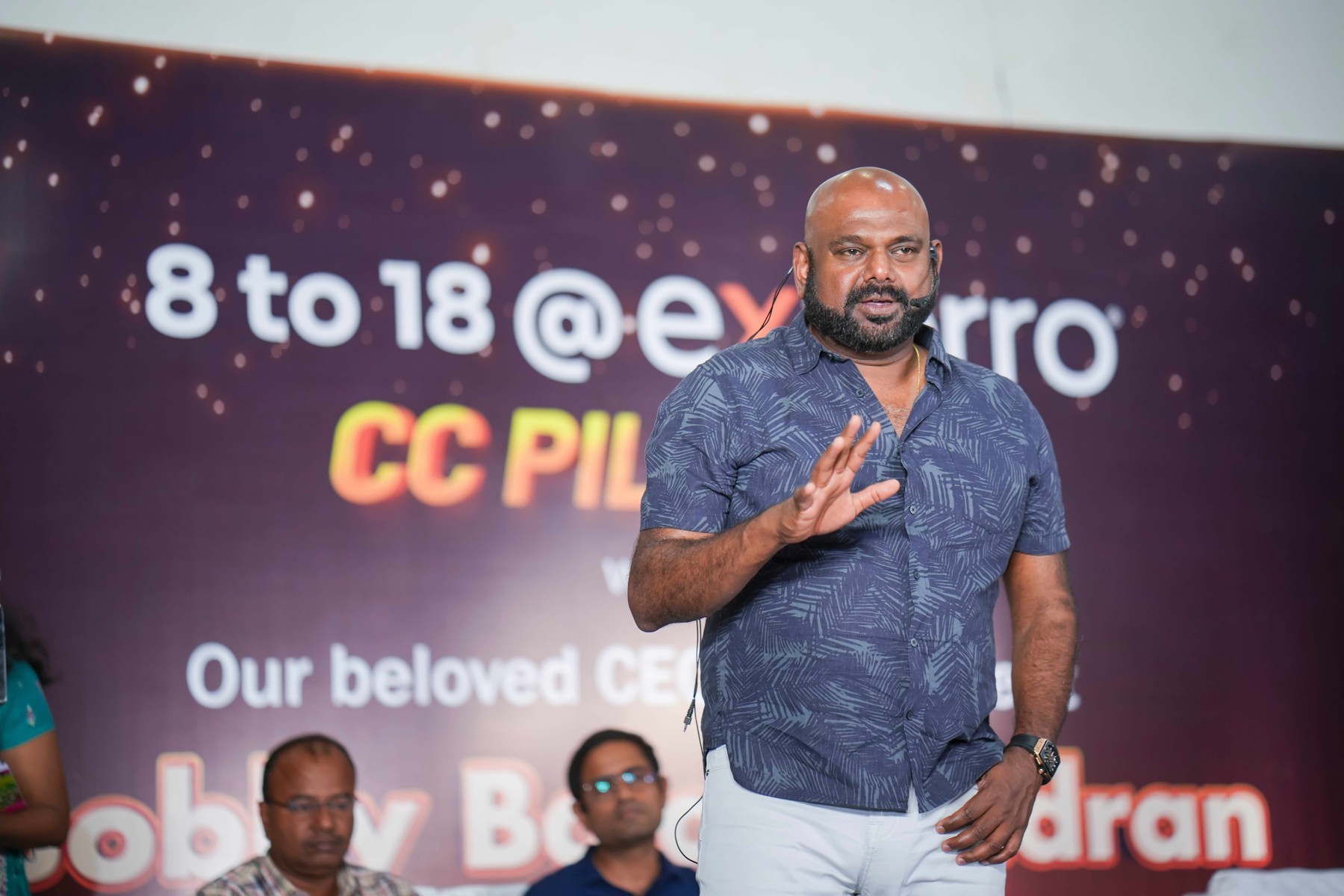 Exterro founder Bobby Balachandran speaking into a headset microphone at a company gathering
