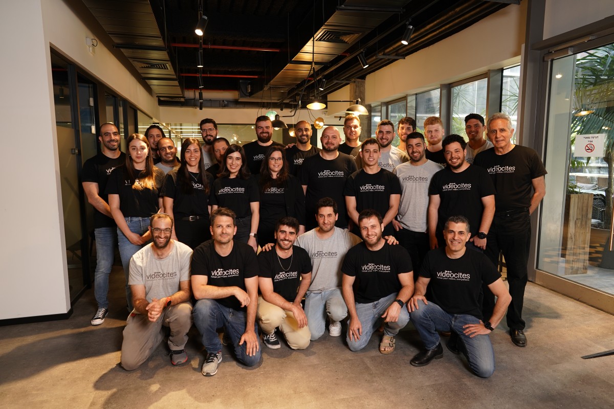 Eyal Arad and the Videocites team gathered in their office in matching company T-shirts.