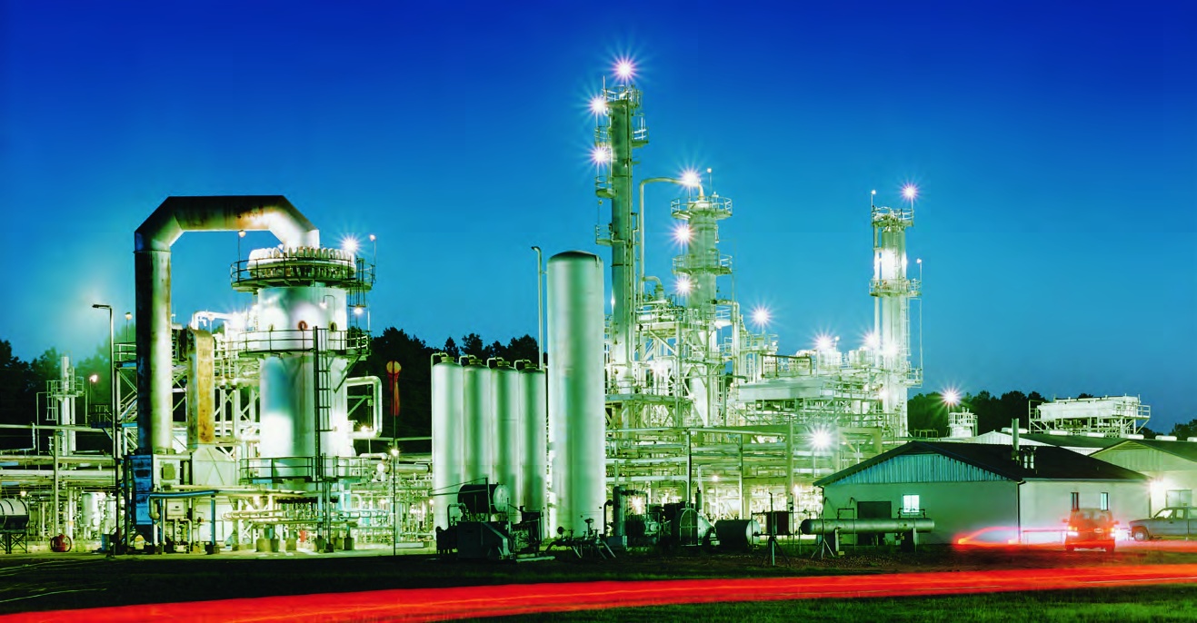 An illuminated Calumet refinery at night, with processing towers and pipework