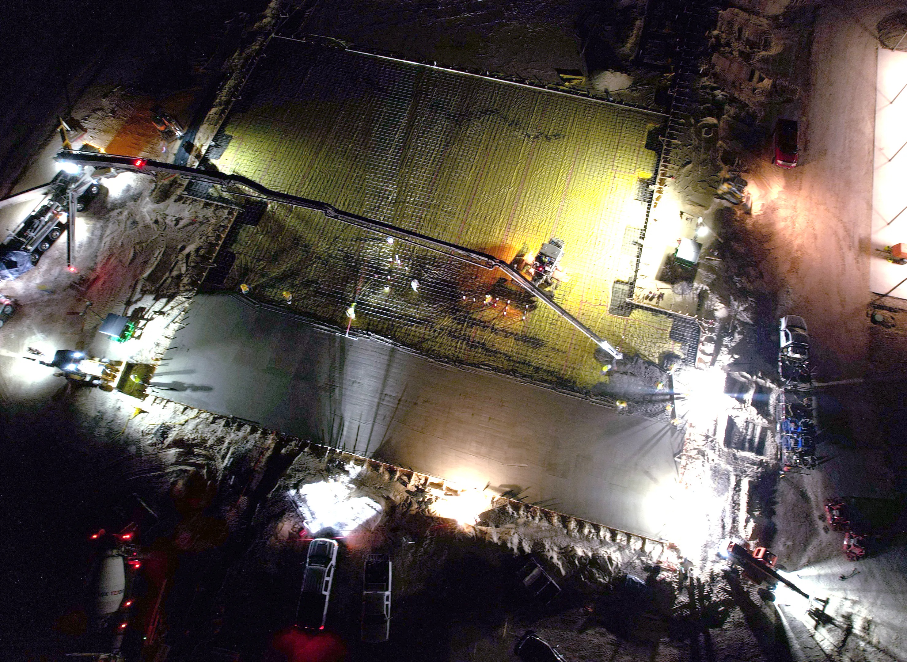 Aerial nighttime view of concrete work at Fab2’s fab-fab construction site