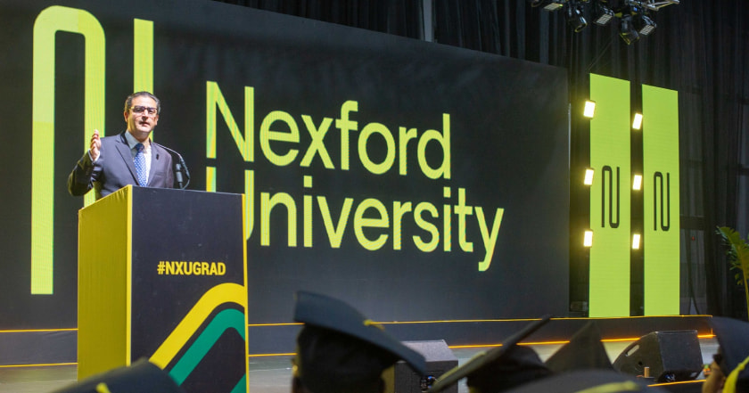 Fadl Al Tarzi speaking from a podium at a Nexford graduation ceremony