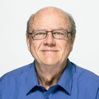 John Fairbank, founding partner of FM3 Research, wearing glasses and a blue shirt