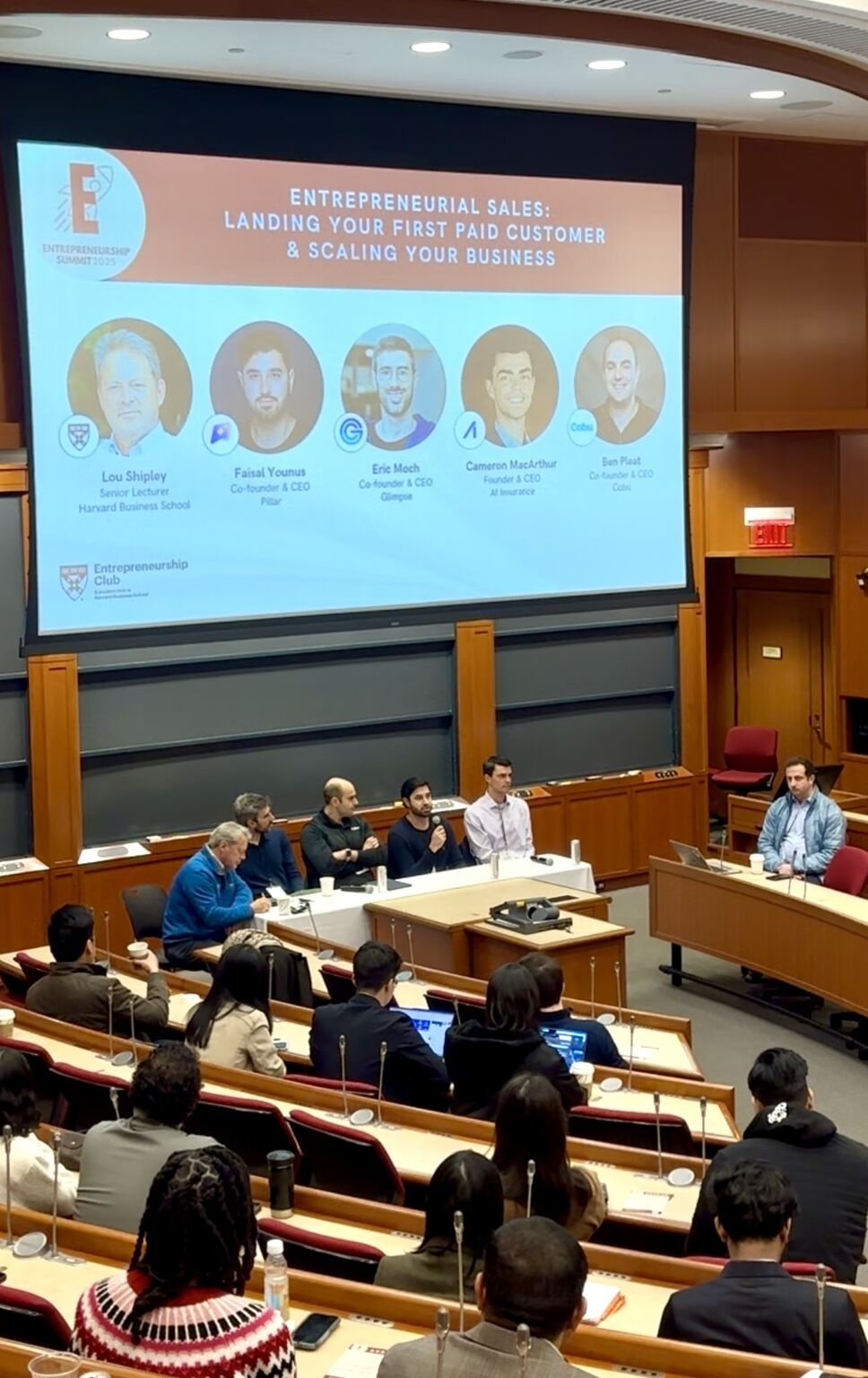 Faisal Younus holding a microphone during the entrepreneurial sales panel at Harvard Business School in 2025
