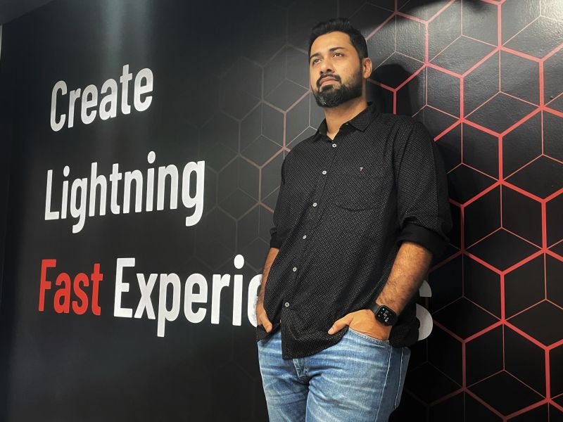 Faiz Mohamed Haneef standing beside a patterned wall at NeoITO