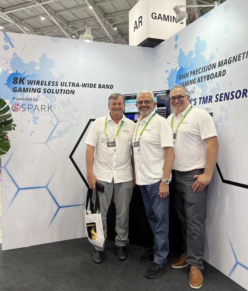 Fares Mubarak standing with SPARK Microsystems colleagues at the iONE booth during Computex 2024