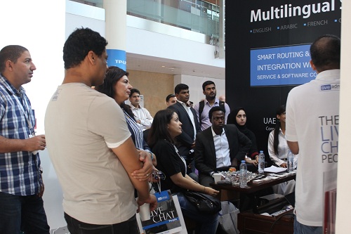 Visitors gather at the LiveAdmins booth to watch a live chat demonstration at GITEX 2014