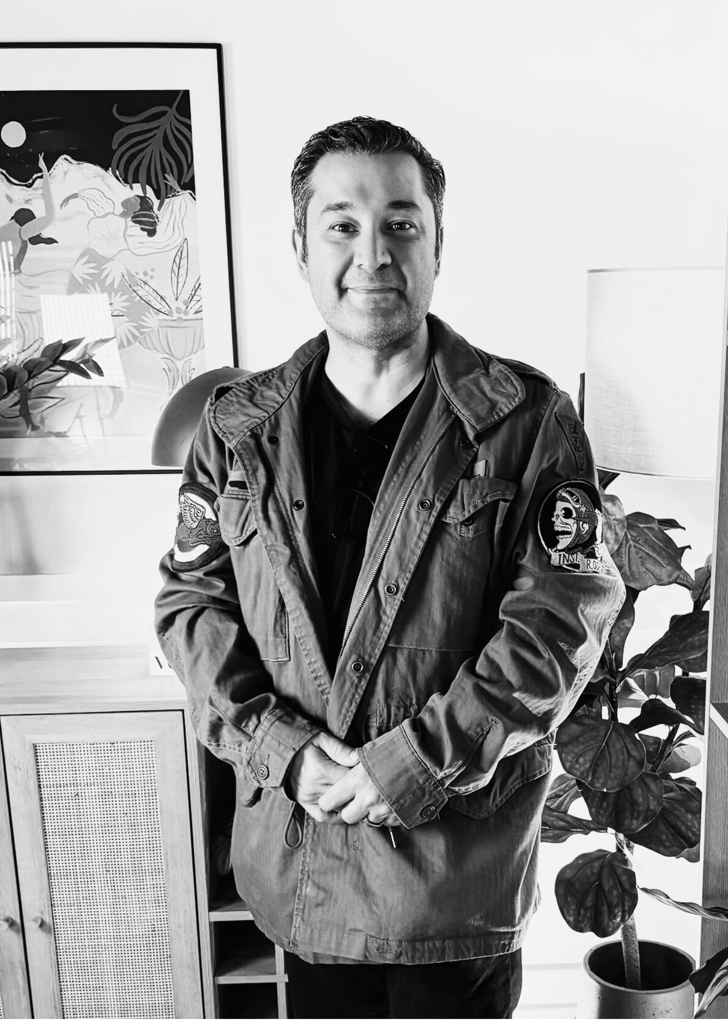Farshid Tafazzoli standing in an interior filled with art and plants