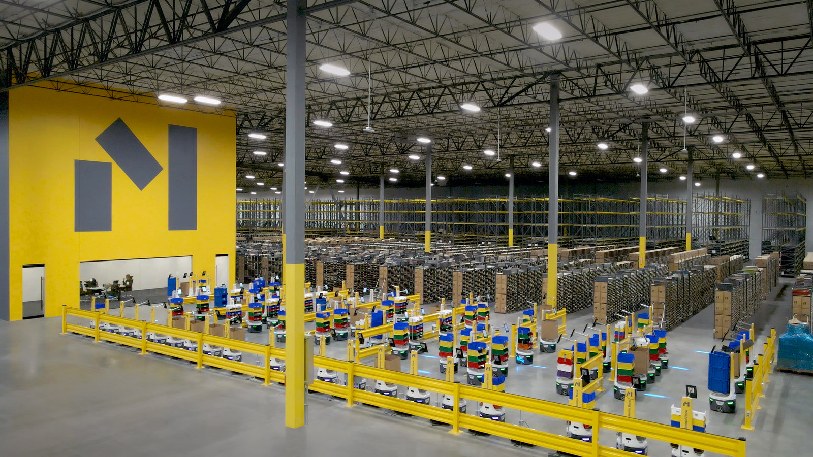 Material Bank warehouse with yellow structural columns and long rows of inventory