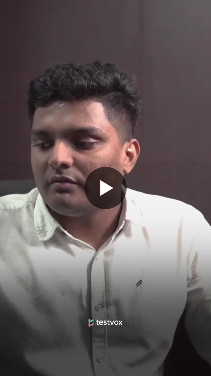 Fasil KK speaking in a Testvox video testimonial, with a play symbol