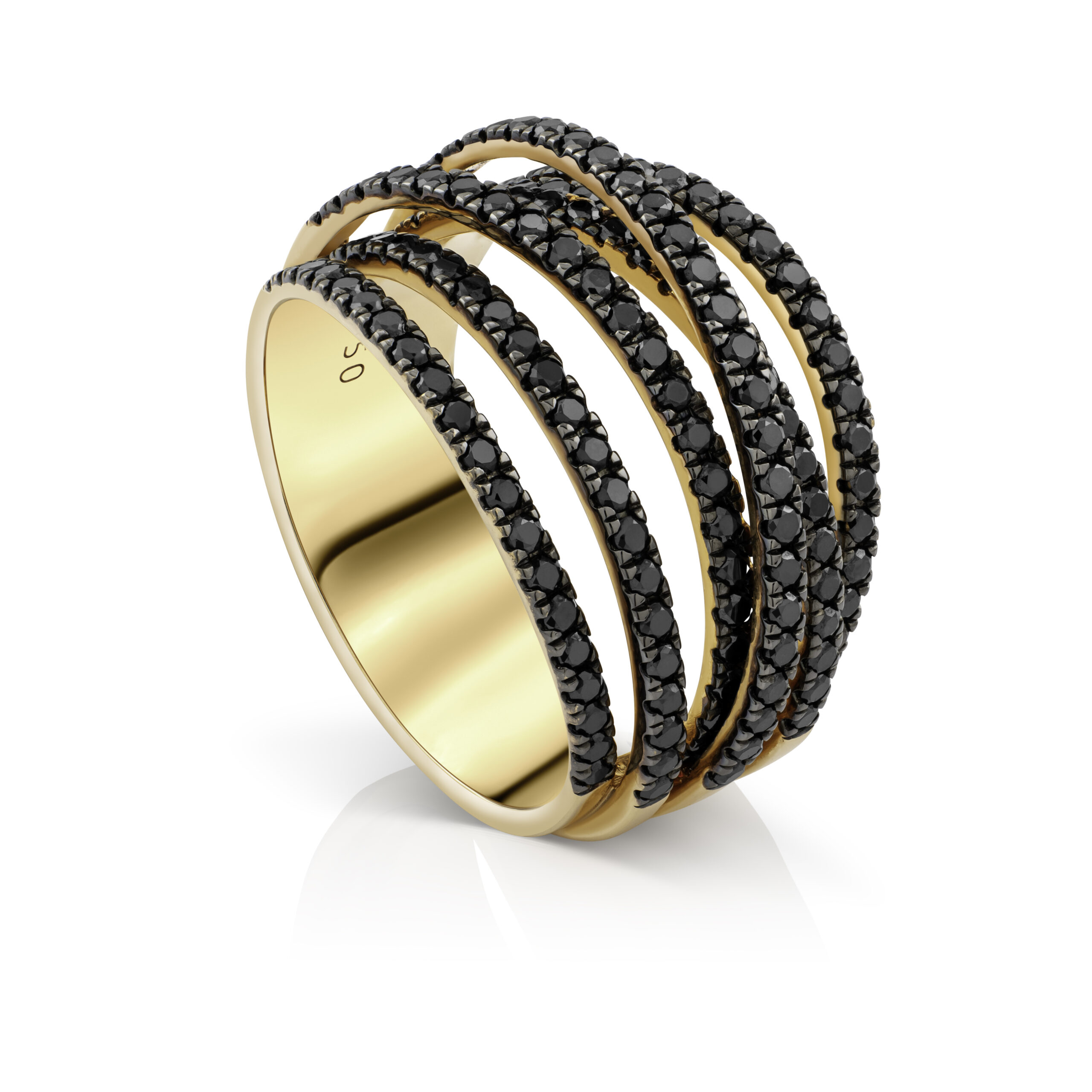 Retouched gold-colored ring with rows of dark stones on a white background