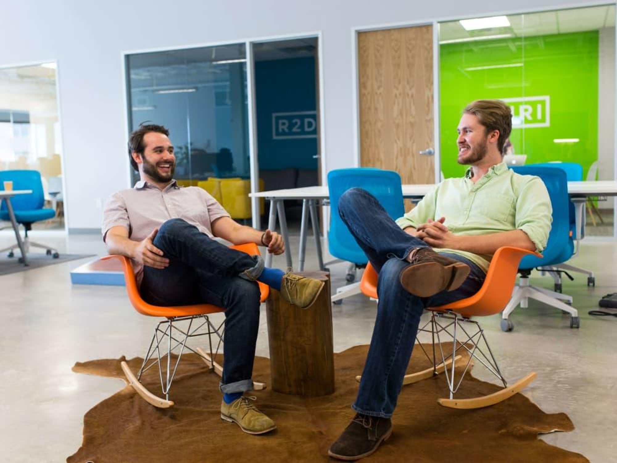 Favor co-founders Ben Doherty and Zac Maurais seated in orange chairs in an office