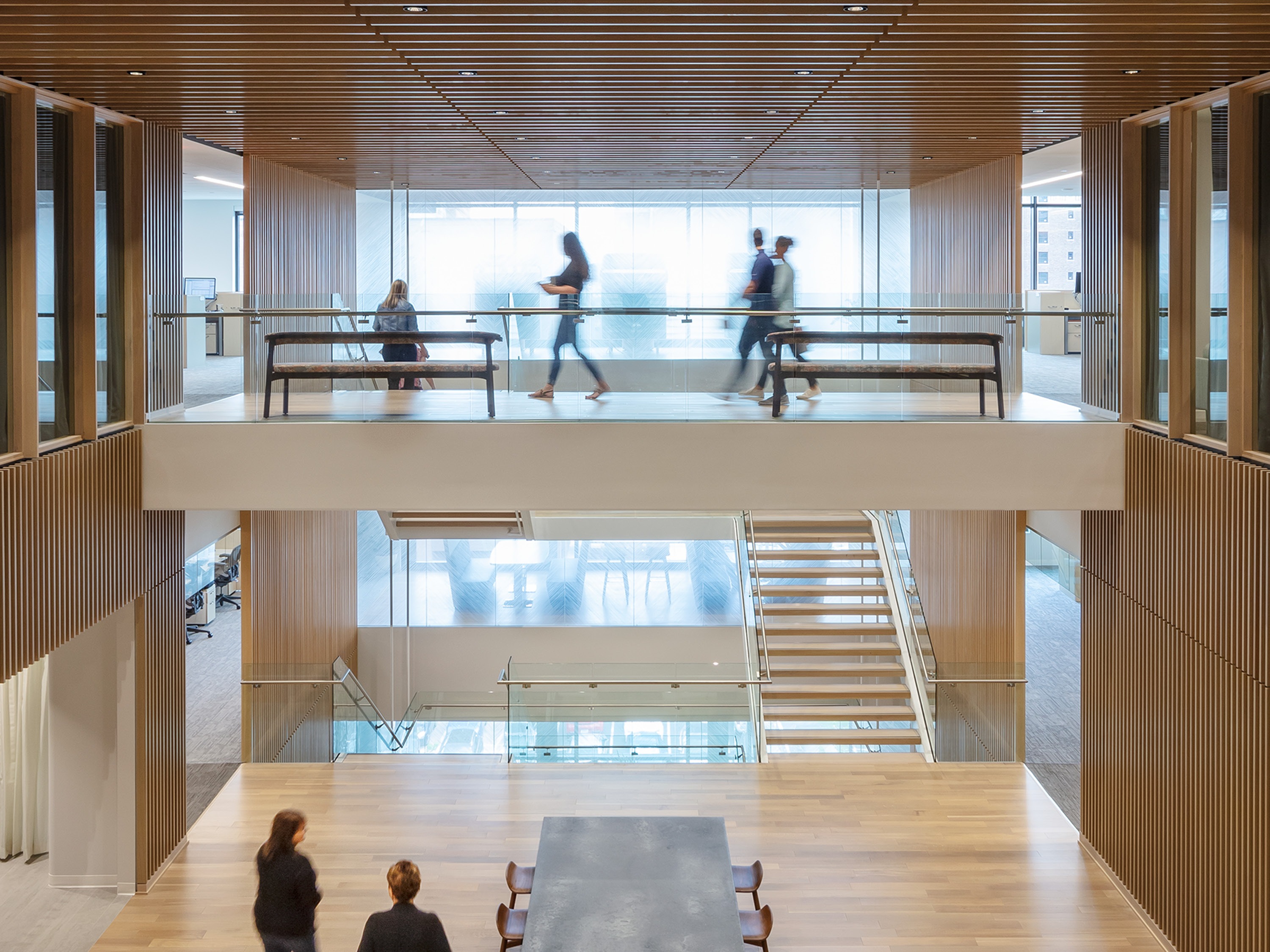 Wood-lined courtyard and open stair connecting floors of the Bank’s Des Moines workplace