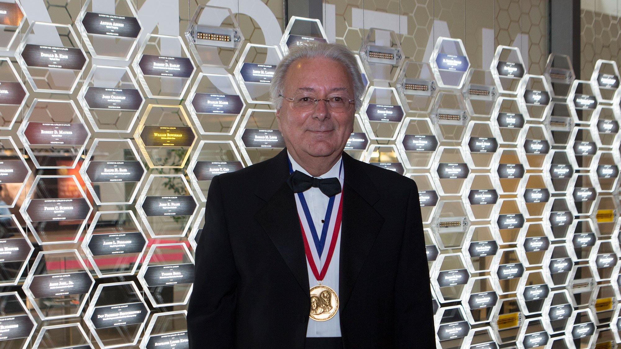 Federico Faggin wearing his medal before the National Inventors Hall of Fame display