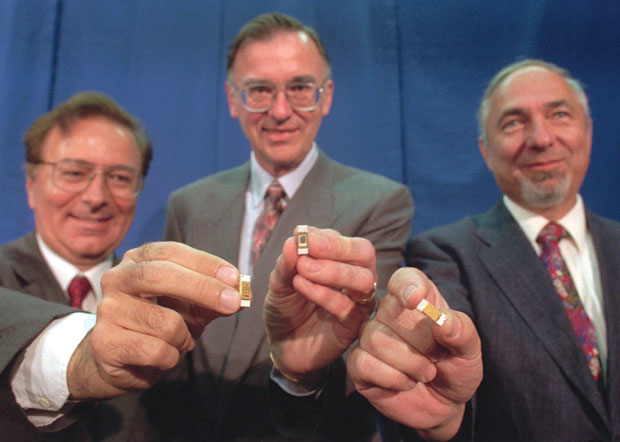 Federico Faggin, Ted Hoff and Stanley Mazor holding microprocessor chips at their 1996 induction ceremony