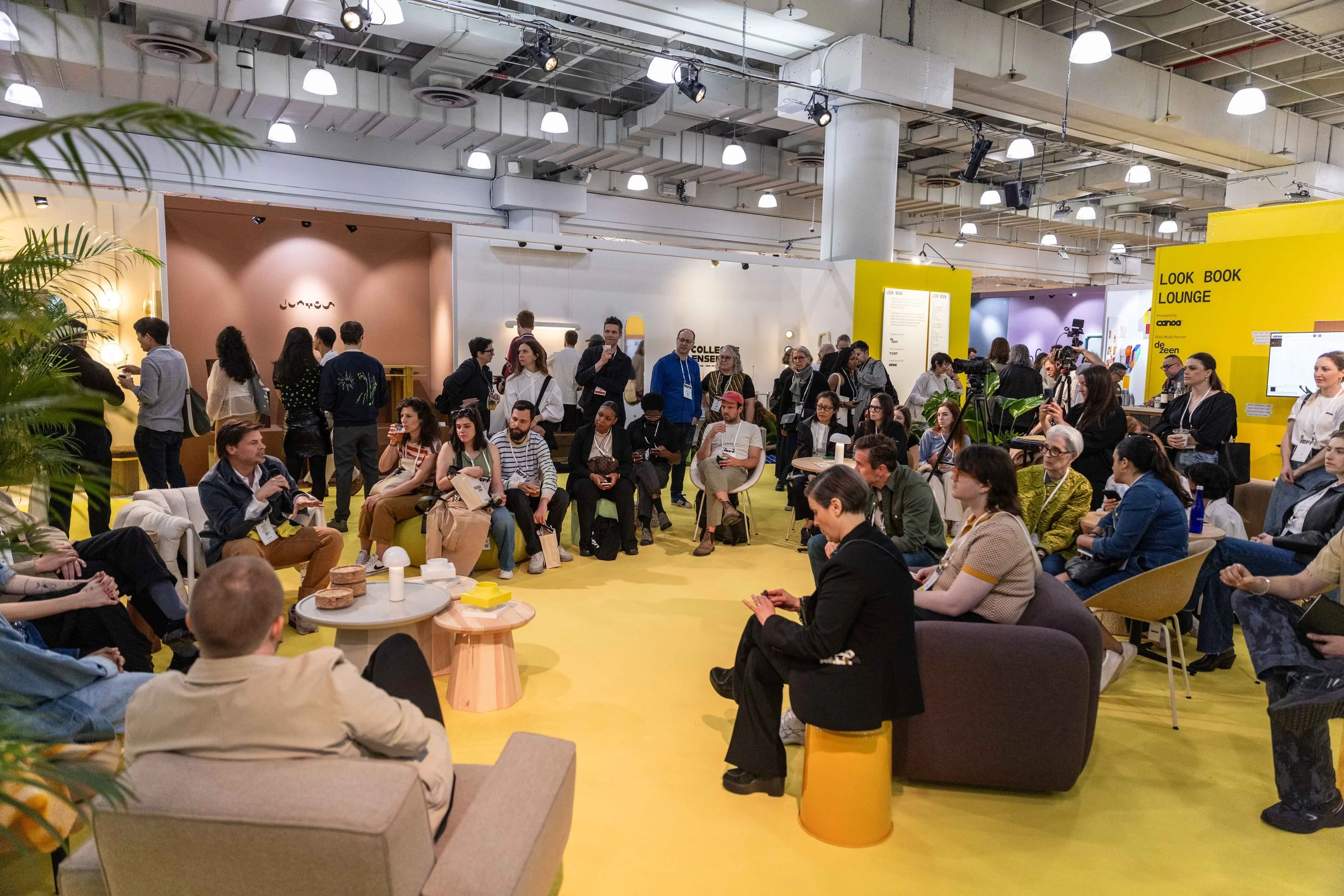 Designers gathered around Federico Negro for a discussion in the yellow Canoa Look Book Lounge