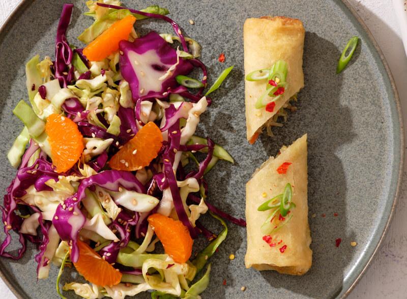 Feel Good Foods egg rolls served with a colorful salad
