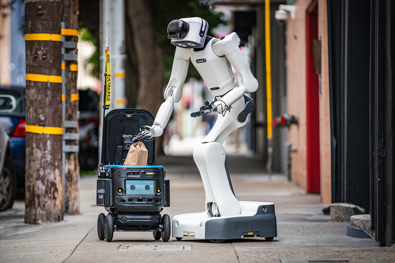 Robot.com’s R-noid handling an order beside an R-kiwi delivery robot