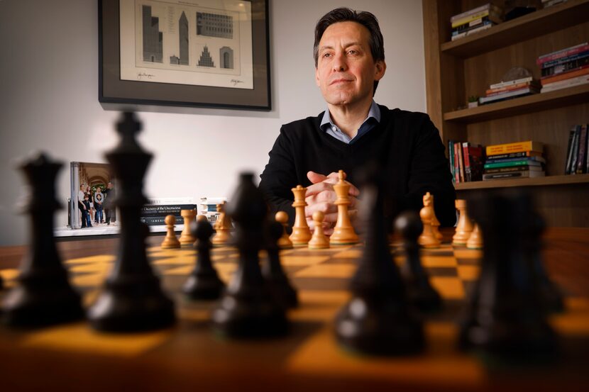 Fernando De Leon seated behind a chessboard in his Dallas office
