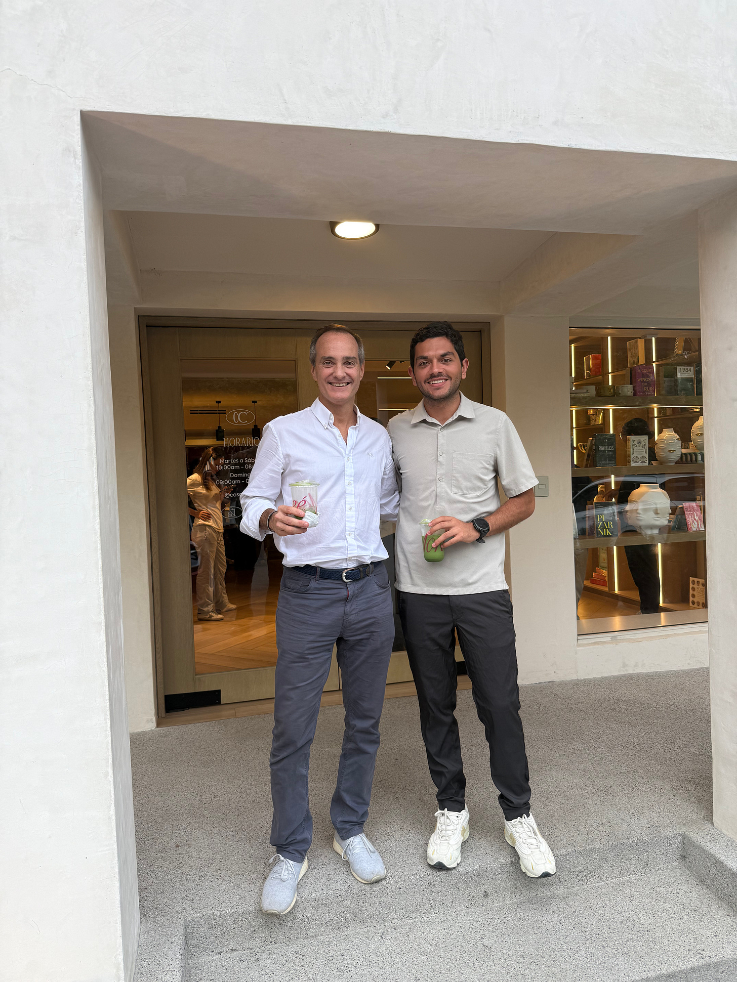 Fernando Poitevin, left, and Alfonso de los Ríos standing together outside a café
